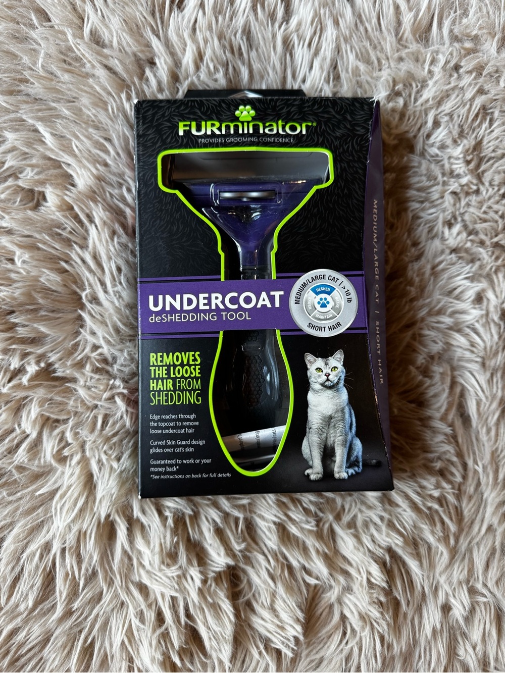 FURminator Undercoat deShedding Tool with Purple Accent and Black Packaging.